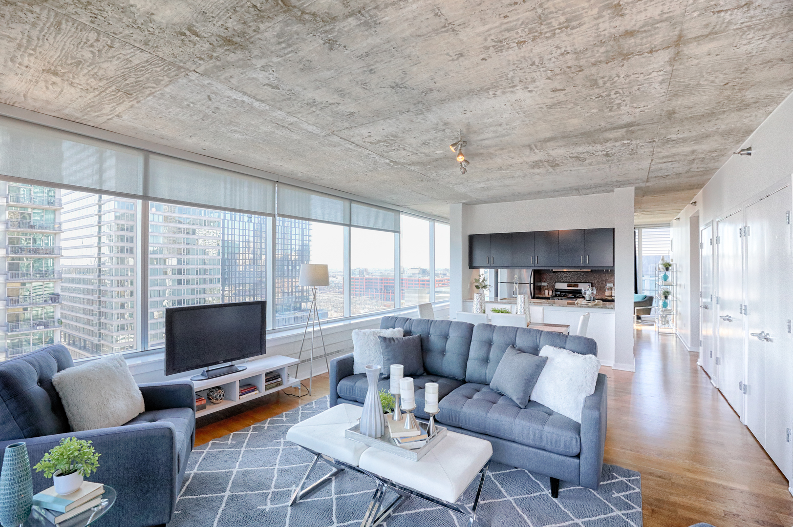 611 South Wells Street, Unit 1507 Chicago, IL 60607 - Photo 6 of 20 a living room with furniture flat screen tv and a large window