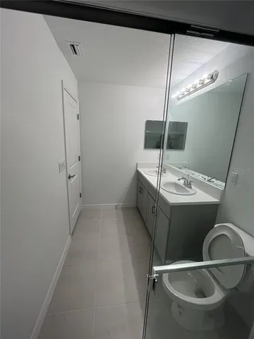 a bathroom with a double vanity sink and mirror