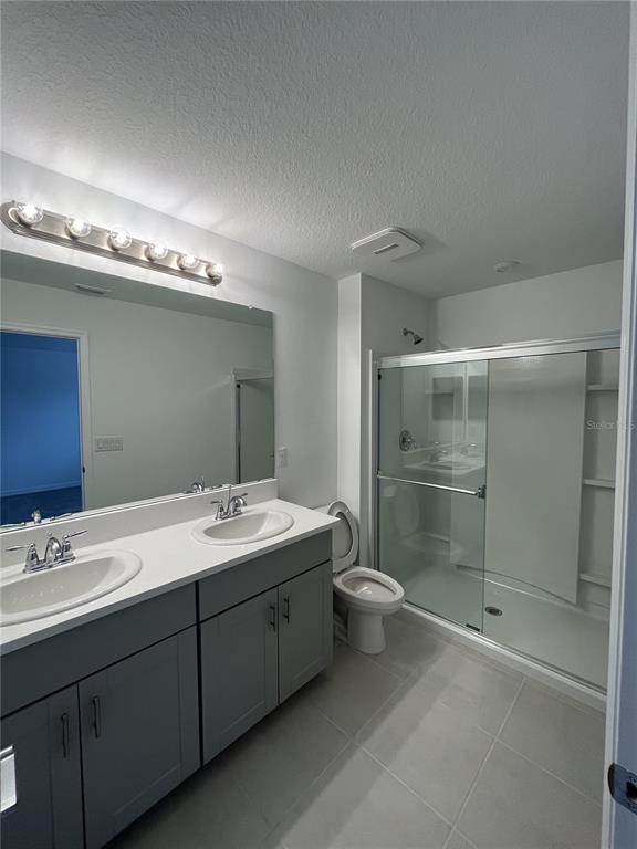 34142 Polacca Lane Wesley Chapel, FL 33543 - Photo 25 of 30 a bathroom with a double vanity sink and mirror