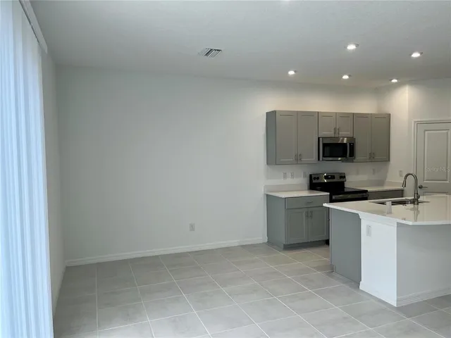 a kitchen with a sink a stove and cabinets