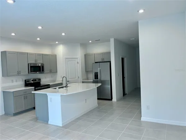 a kitchen with stainless steel appliances a sink stove and refrigerator