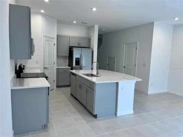 a kitchen with a sink stove and refrigerator