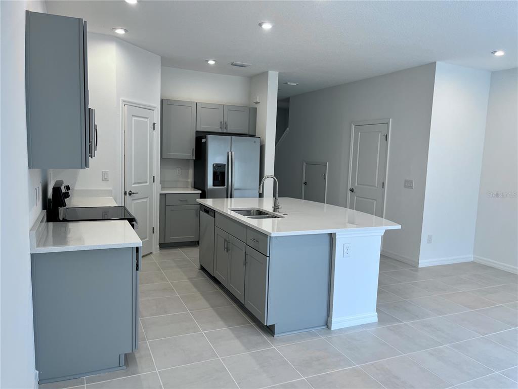 34142 Polacca Lane Wesley Chapel, FL 33543 - Photo 7 of 30 a kitchen with a sink stove and refrigerator
