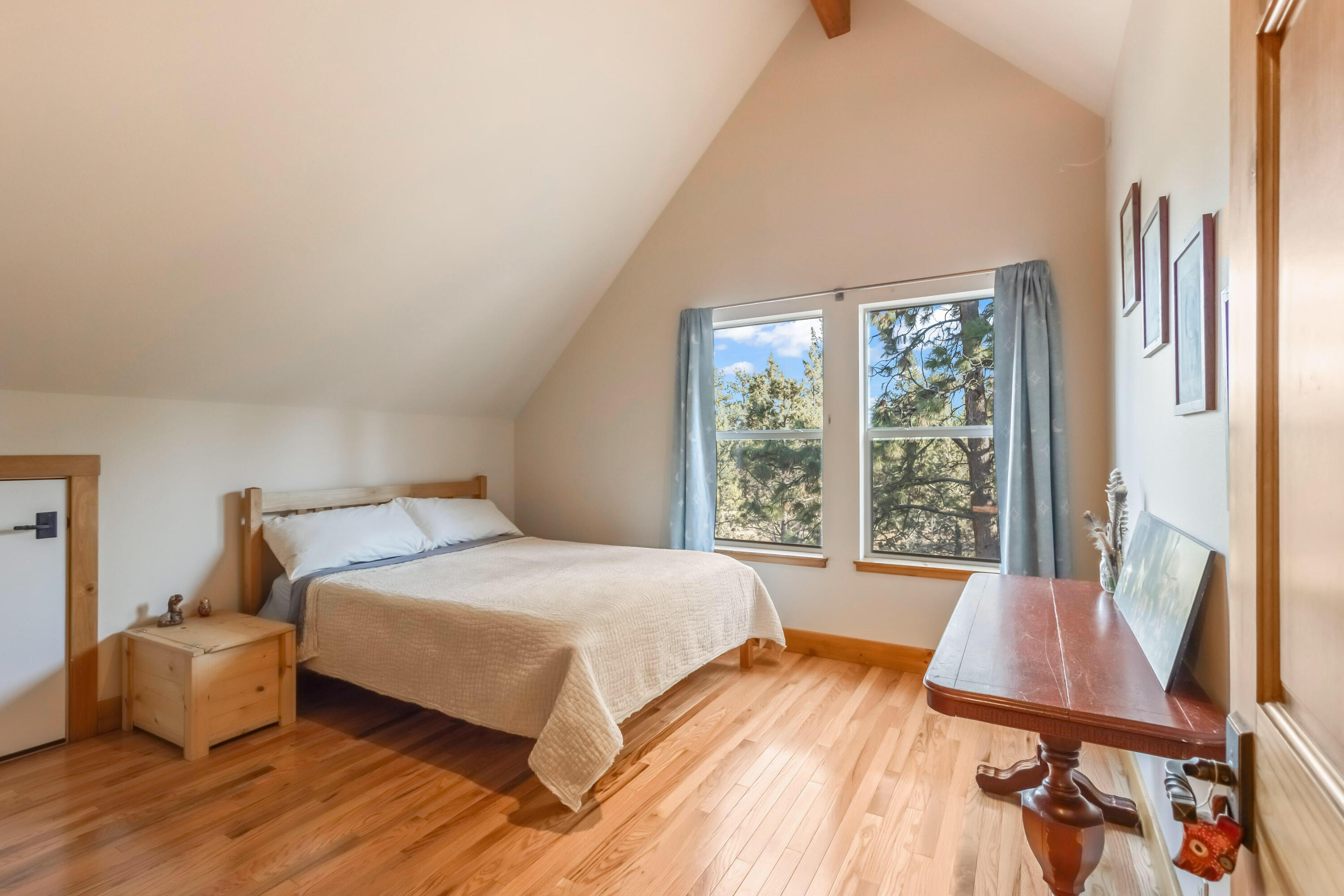 69590 Omaha Road Sisters, OR 97759 - Photo 25 of 46 a bedroom with a bed and wooden floor