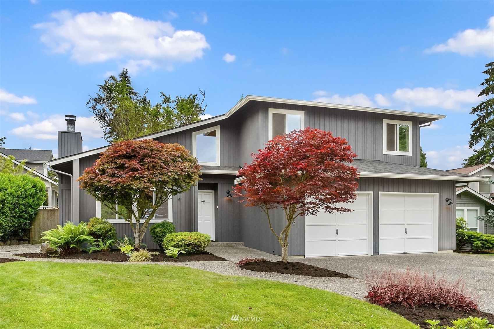 a front view of house with a garden