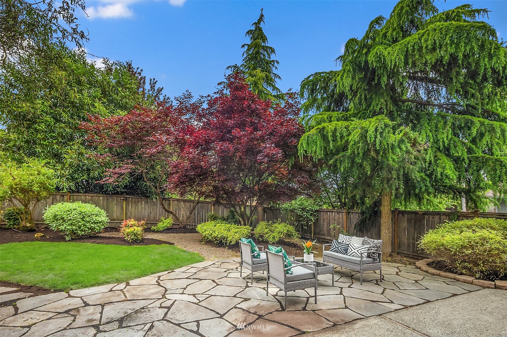 9009 Northeast 138th Place Kirkland, WA 98034 - Photo 14 of 30 a view of a chair and table in the garden
