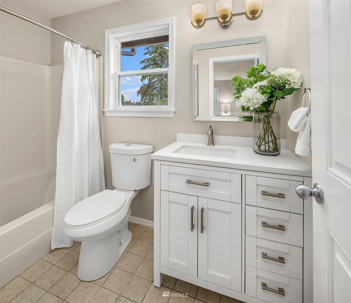 9009 Northeast 138th Place Kirkland, WA 98034 - Photo 17 of 30 a bathroom with a sink a toilet and a mirror