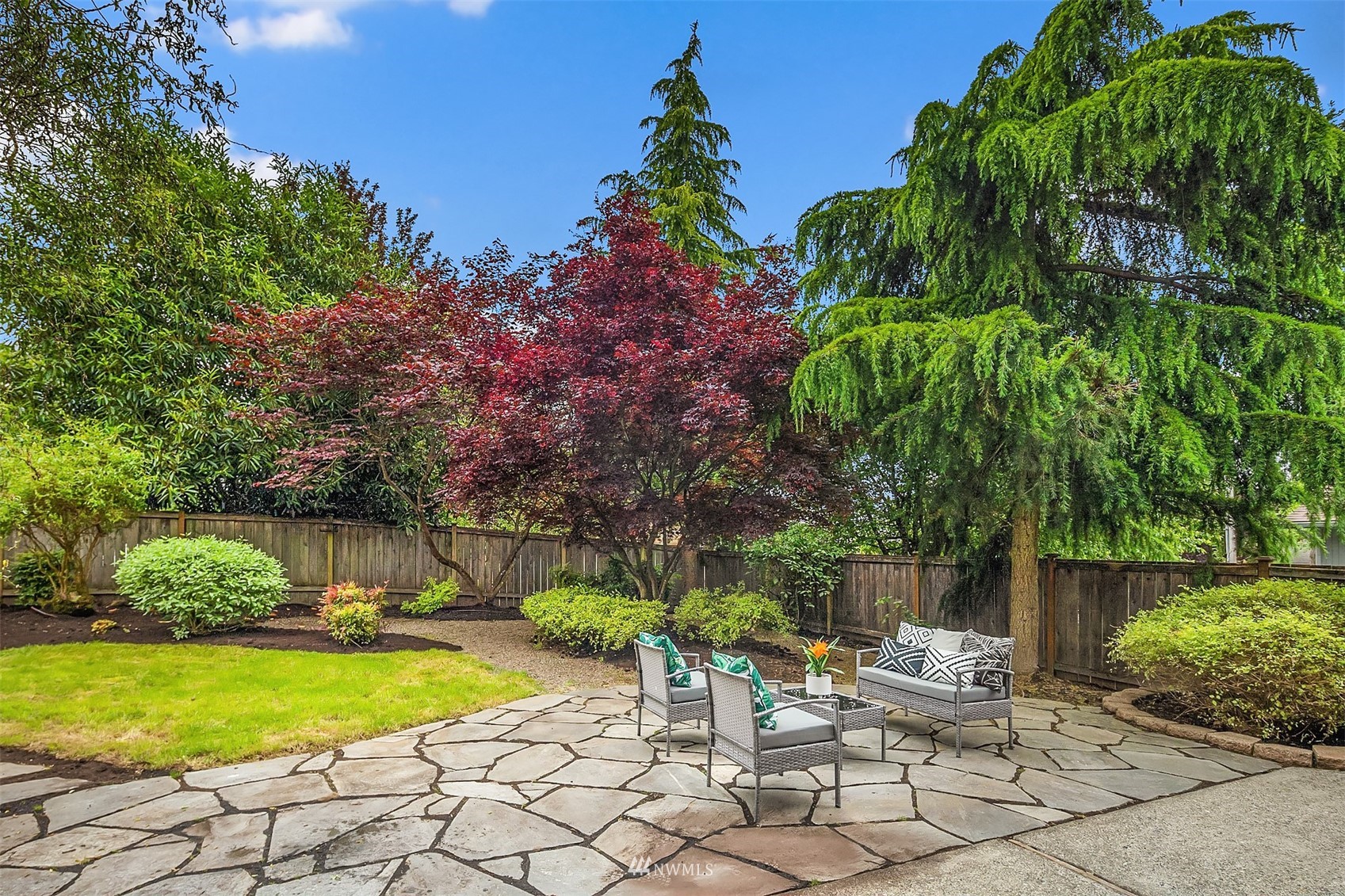 9009 Northeast 138th Place Kirkland, WA 98034 - Photo 24 of 30 a view of a chair and table on the garden