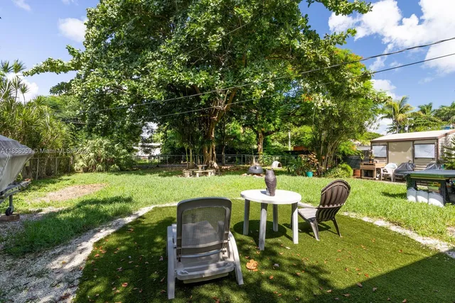 a swimming pool with outdoor seating and yard