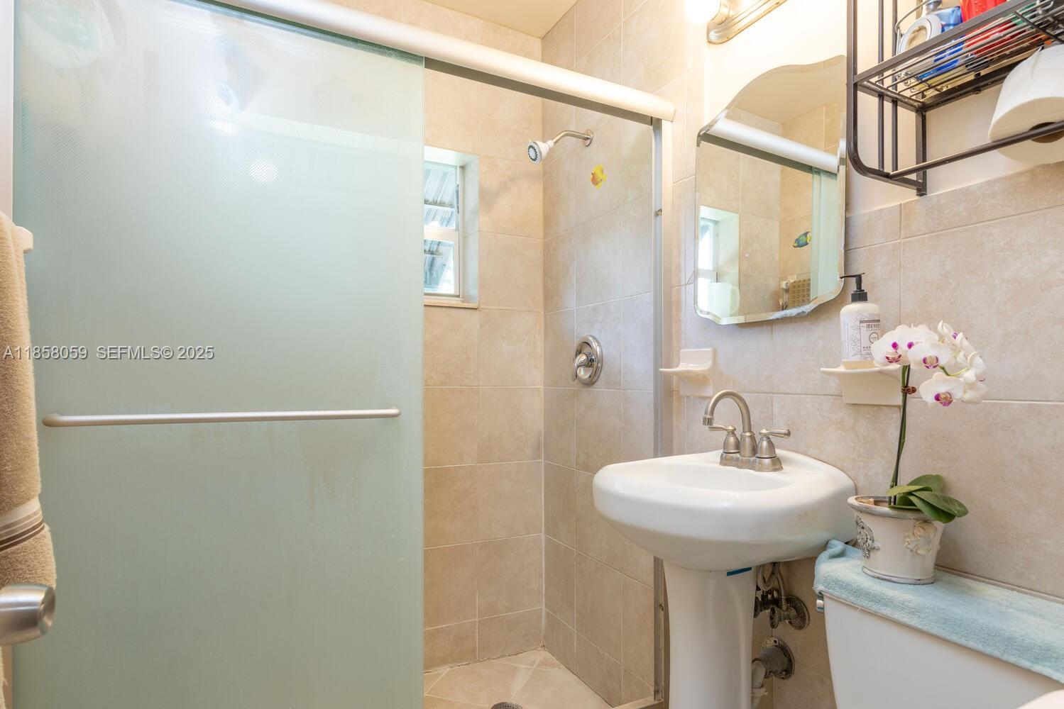 846 Northwest 3rd Avenue Homestead, FL 33030 - Photo 3 of 13 a bathroom with a sink and mirror