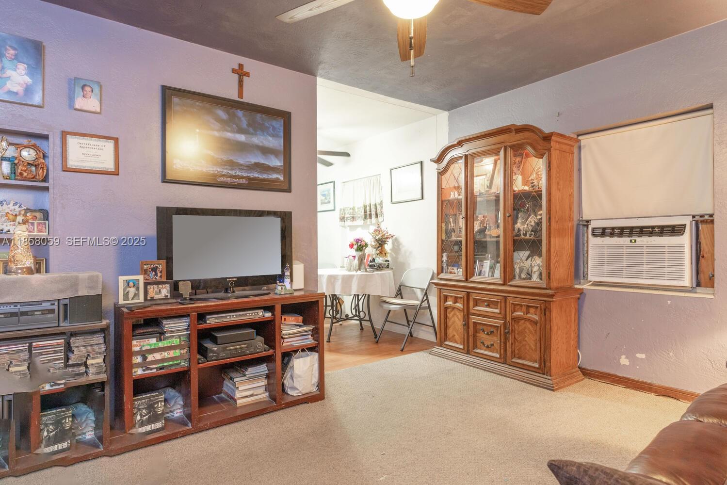 846 Northwest 3rd Avenue Homestead, FL 33030 - Photo 4 of 13 a living room with furniture a flat screen tv and kitchen view