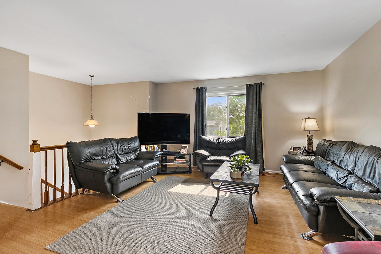 114 Sherman Street Bartlett, IL 60103 - Photo 2 of 17 a living room with furniture and a flat screen tv