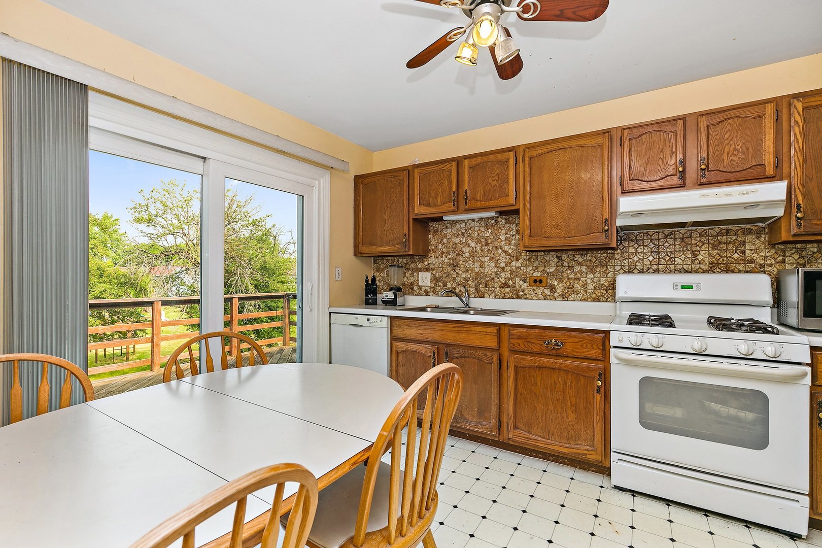 114 Sherman Street Bartlett, IL 60103 - Photo 4 of 17 a kitchen with granite countertop a stove a sink and a refrigerator