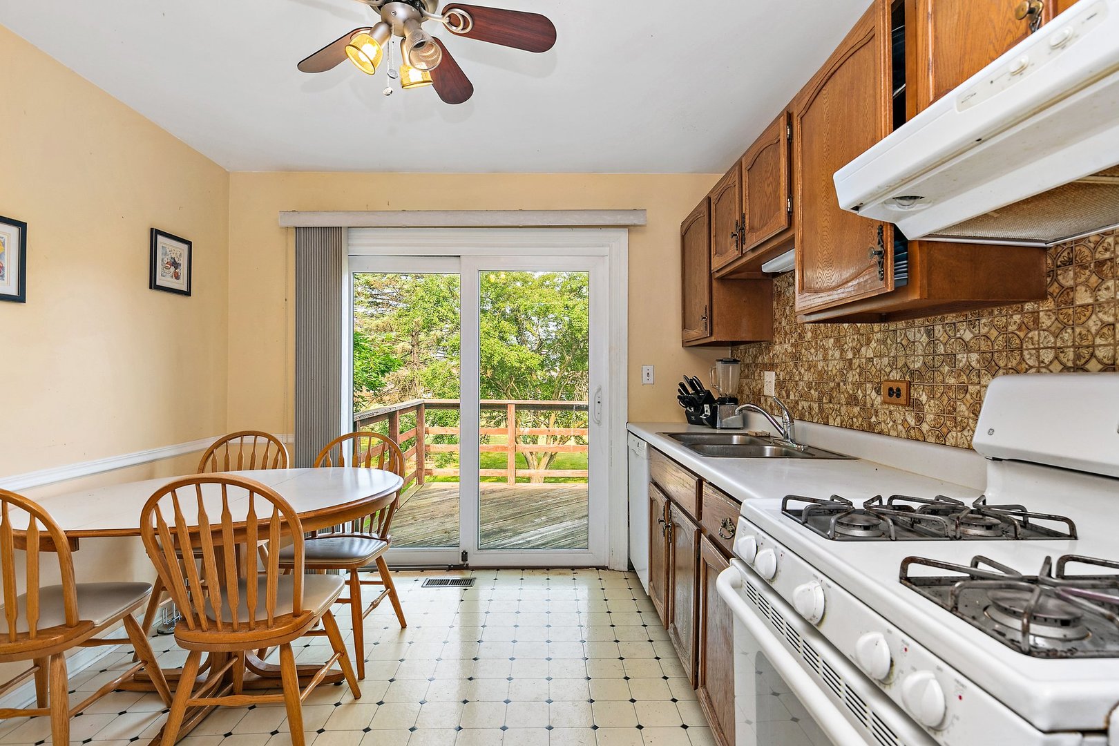 114 Sherman Street Bartlett, IL 60103 - Photo 5 of 17 a kitchen with a stove a sink and a dining table