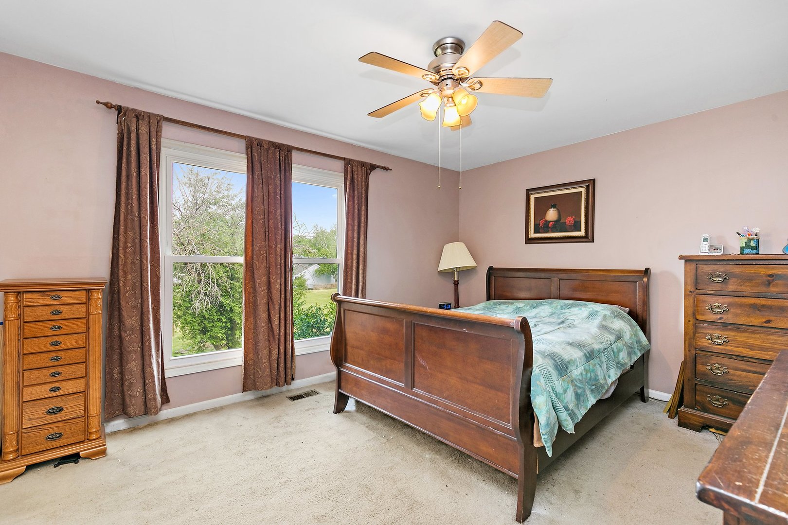 114 Sherman Street Bartlett, IL 60103 - Photo 6 of 17 a bedroom with a bed and a chandelier