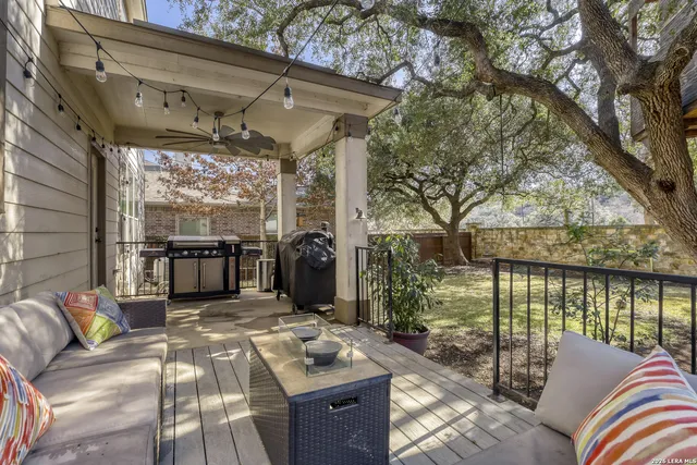 a balcony with furniture and a potted plant