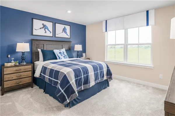 a spacious bedroom with a bed and a large window