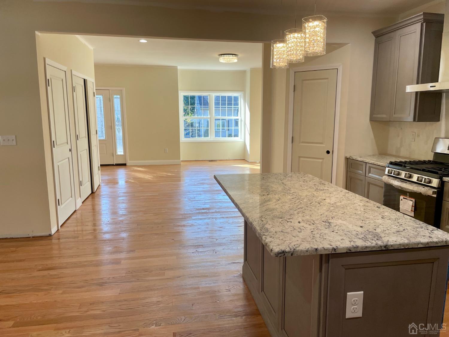 125 Ridge Road Colonia, NJ 07067 - Photo 4 of 26 a kitchen with granite countertop a stove and a wooden floors
