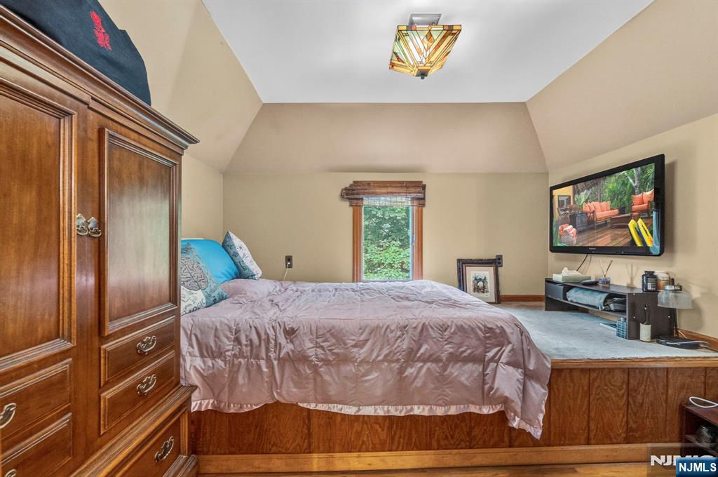 5110 Berkshire Valley Road Oak Ridge, NJ 07438 - Photo 28 of 49 a bedroom with a bed and a flat screen tv