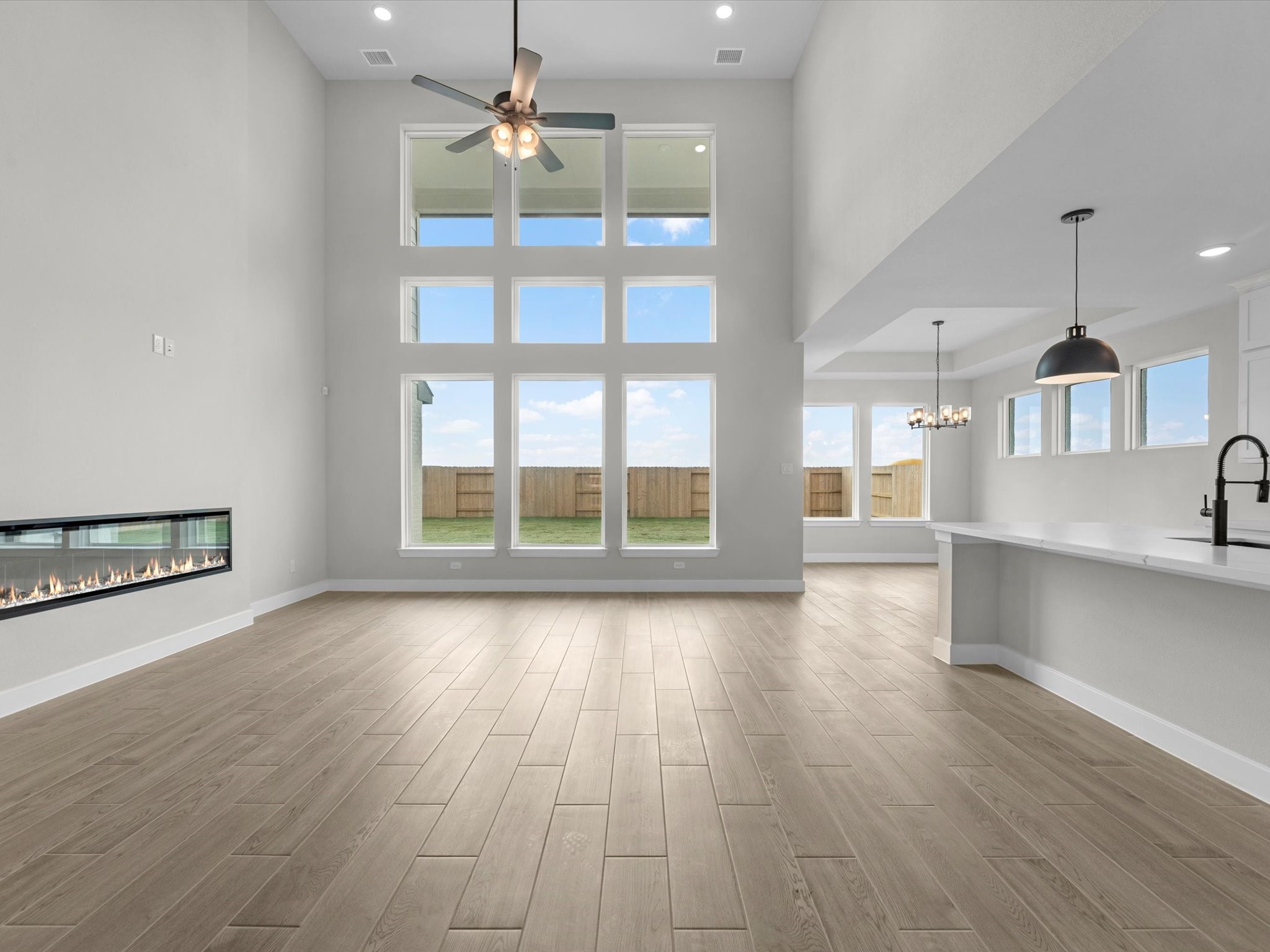 5023 McKinney Rdg Trail Rosenberg, TX 77471 - Photo 3 of 27 an empty room with wooden floor and windows