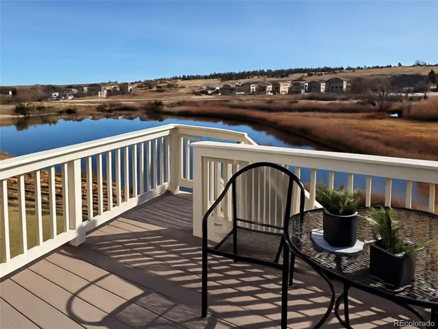 a view of a chairs and table in the balcony
