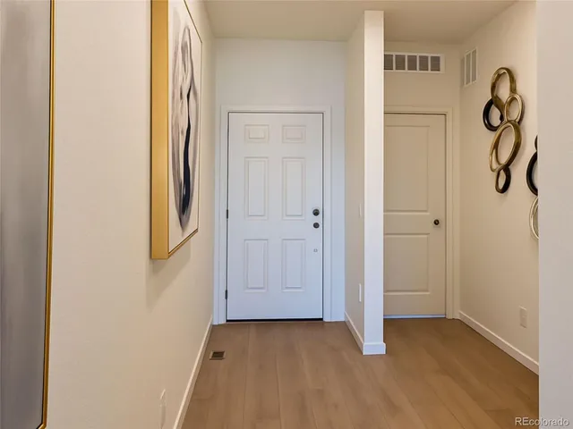 a view of an entryway with wooden floor