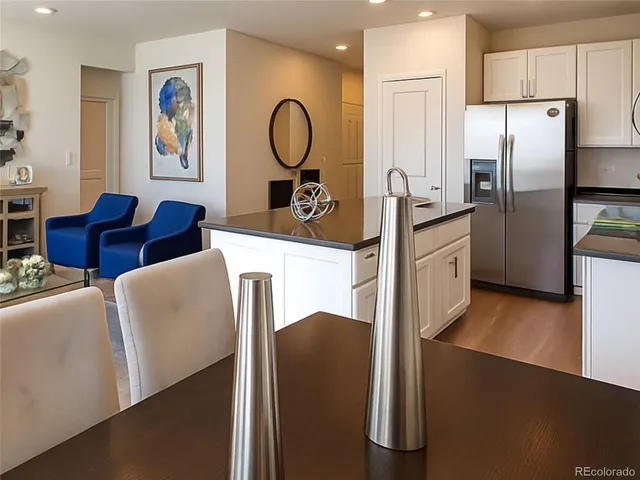 a kitchen with stainless steel appliances granite countertop a refrigerator a stove and a refrigerator