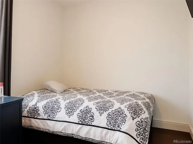 a bathroom with a granite countertop toilet sink and mirror