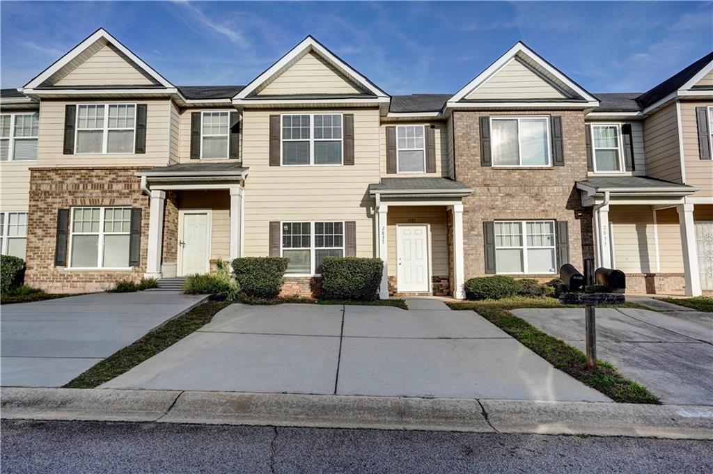 2837 Laurel Ridge Circle Atlanta, GA 30344 - Photo 1 of 20 a front view of a house with a yard
