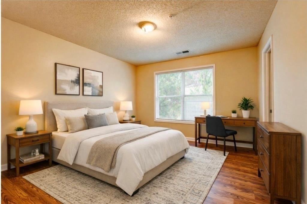 2837 Laurel Ridge Circle Atlanta, GA 30344 - Photo 17 of 20 a bedroom with a bed and wooden floor