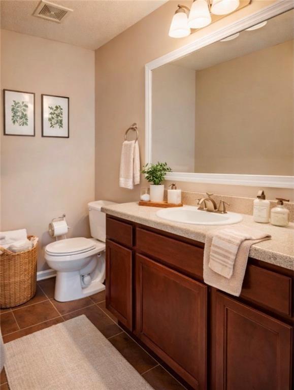 2837 Laurel Ridge Circle Atlanta, GA 30344 - Photo 18 of 20 a bathroom with a toilet a sink and mirror