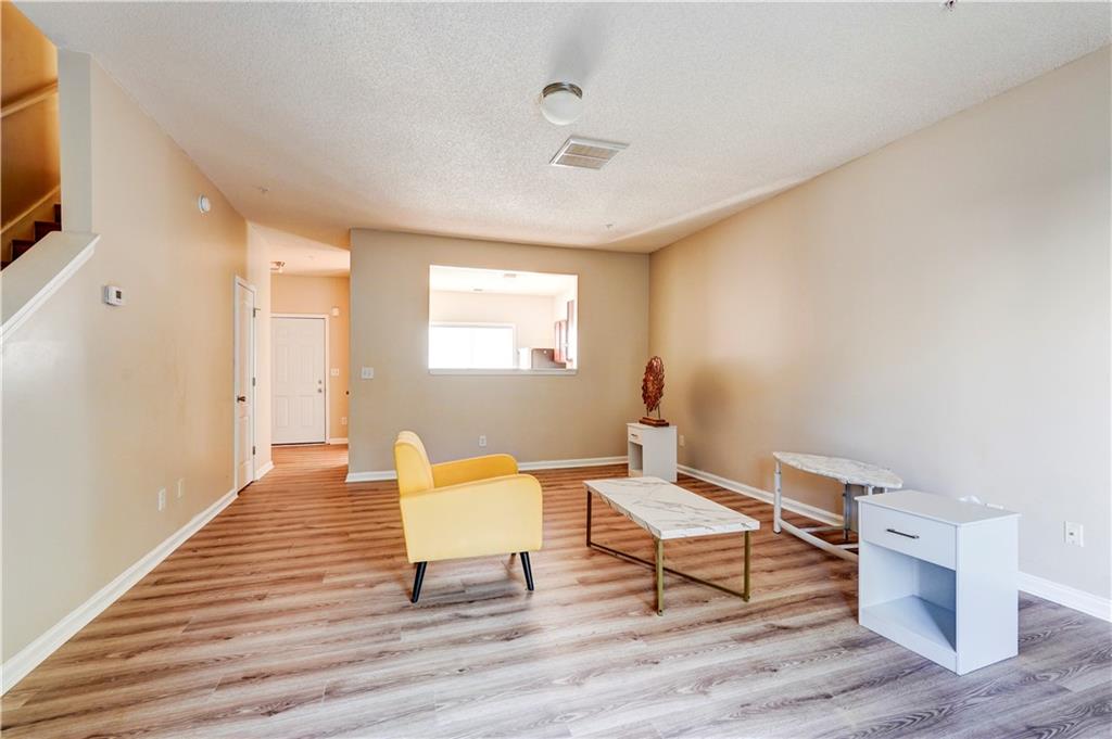 2837 Laurel Ridge Circle Atlanta, GA 30344 - Photo 5 of 20 a living room with furniture a flat screen tv and a window
