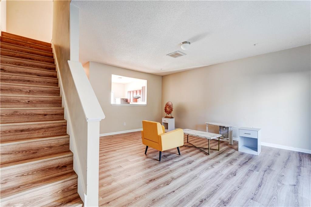 2837 Laurel Ridge Circle Atlanta, GA 30344 - Photo 6 of 20 a living room with furniture and a wooden floor