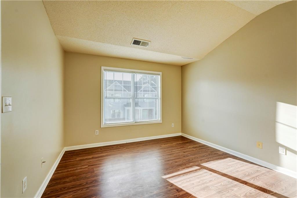 2837 Laurel Ridge Circle Atlanta, GA 30344 - Photo 7 of 20 an empty room with wooden floor and windows