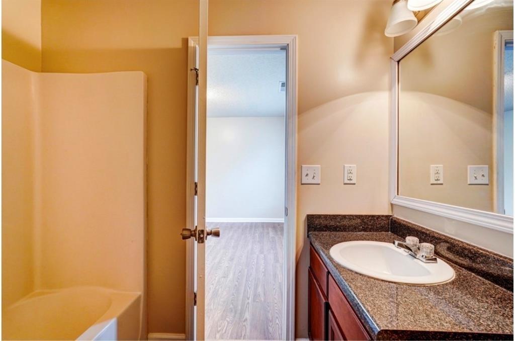 2837 Laurel Ridge Circle Atlanta, GA 30344 - Photo 9 of 20 a bathroom with a granite countertop sink and a mirror