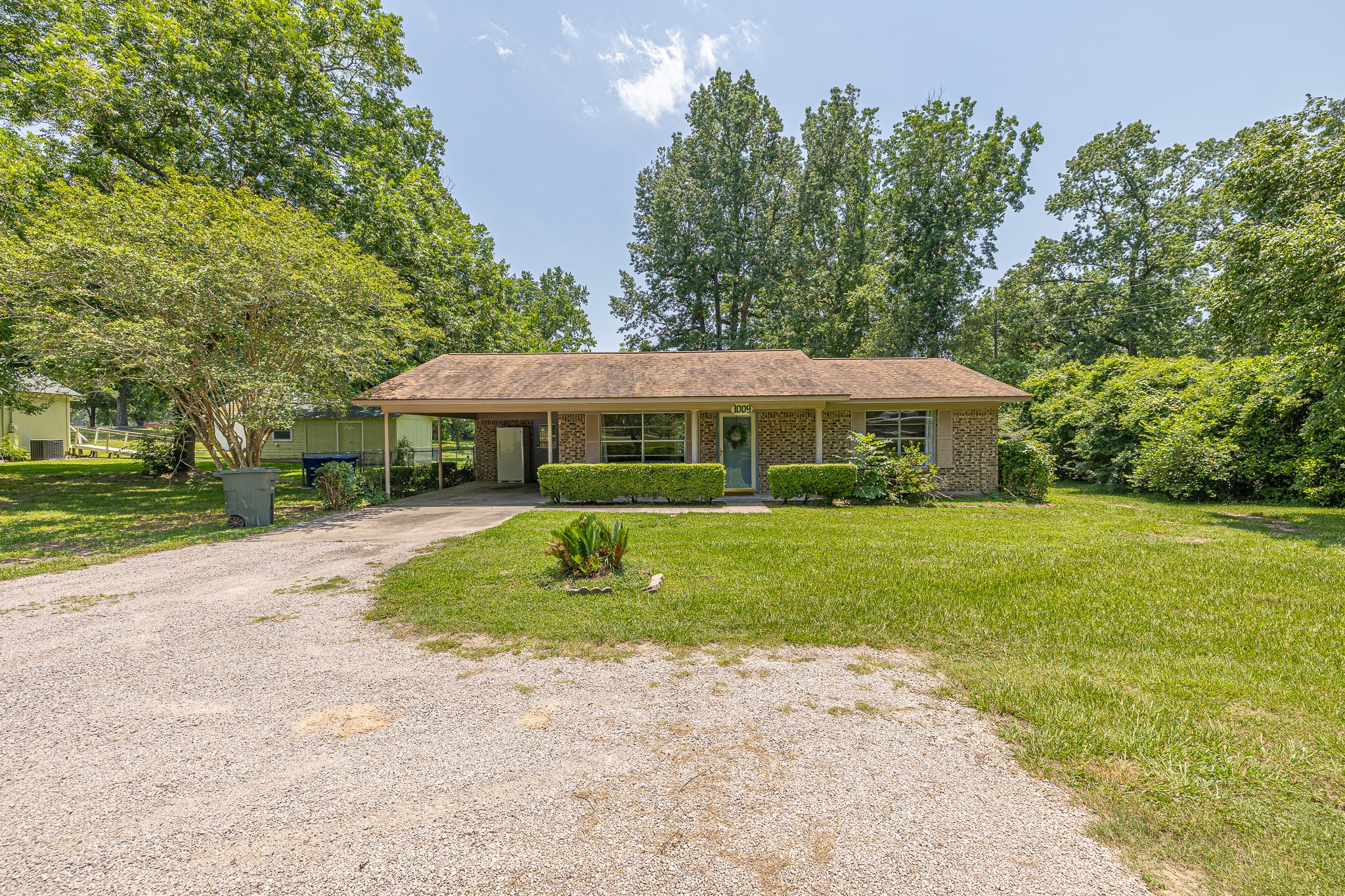 1009 Fish Hatchery Road Huntsville, TX 77320 - Photo 1 of 16 a front view of a house with a yard