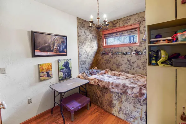 a view of a bedroom with furniture and window