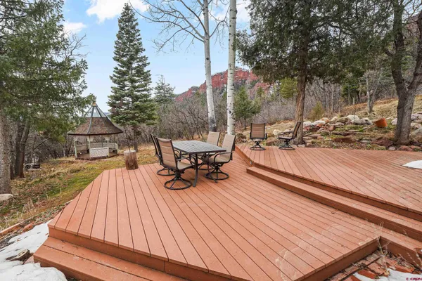 a view of a house with a yard and a large tree