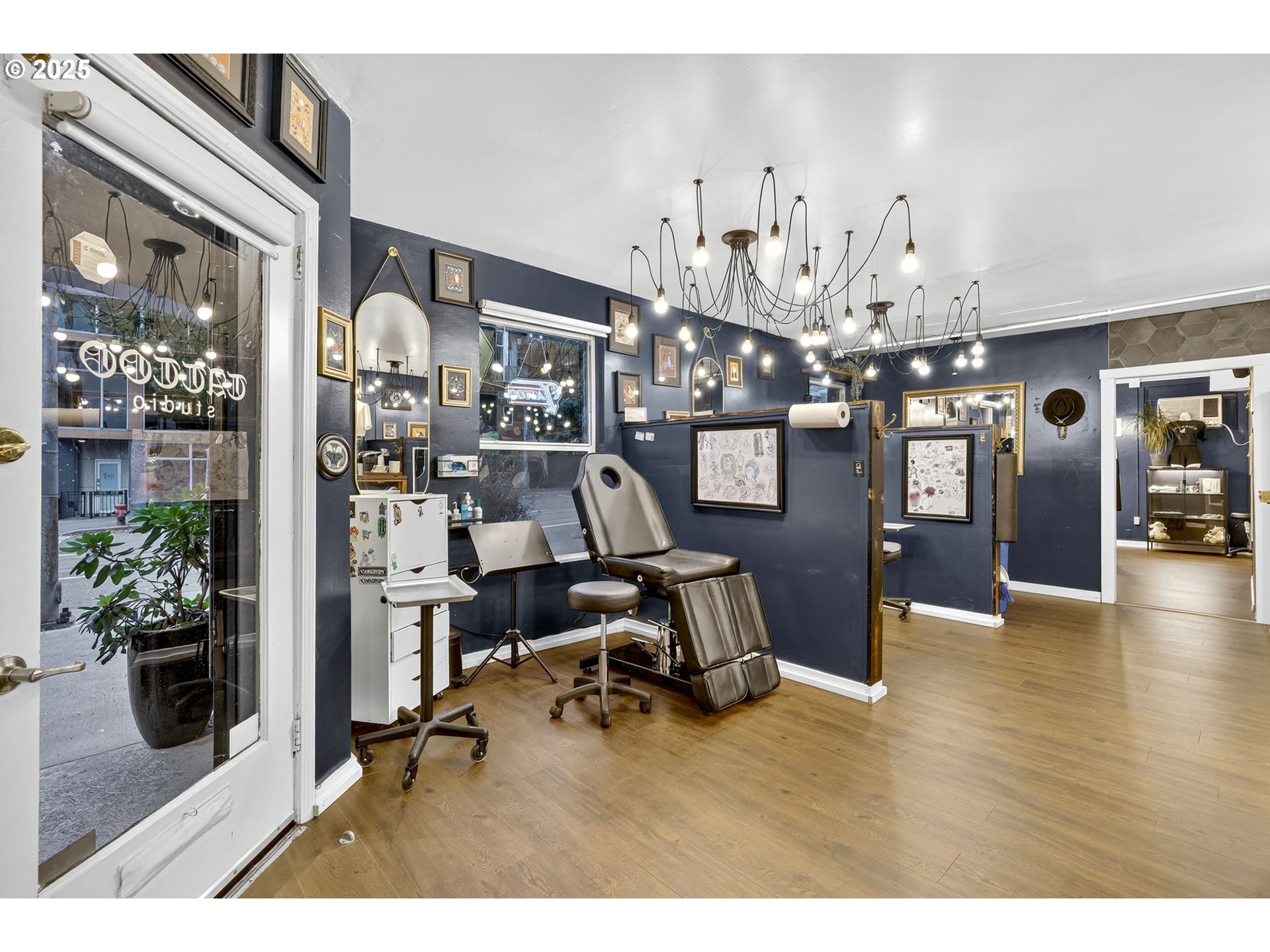 1104 Southwest Columbia Street, Unit 1 Portland, OR 97201 - Photo 3 of 20 a room with lots of wooden furniture and windows