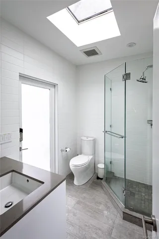 a bathroom with a toilet sink and shower