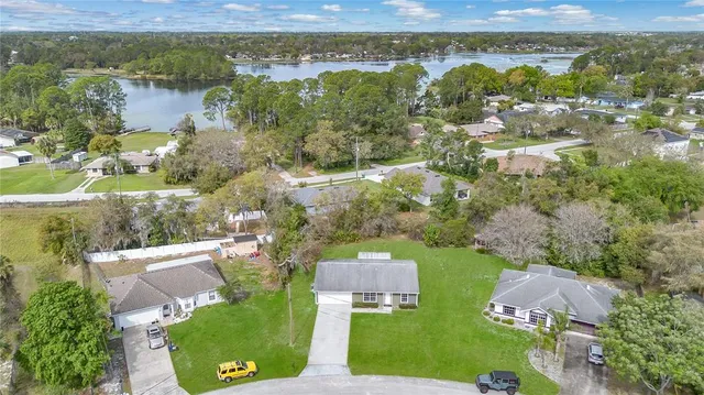 an aerial view of residential houses with outdoor space and river