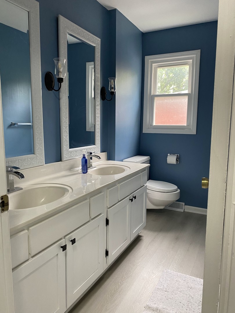1408 Killdeer Drive Naperville, IL 60565 - Photo 24 of 43 a bathroom with a toilet sink and mirror