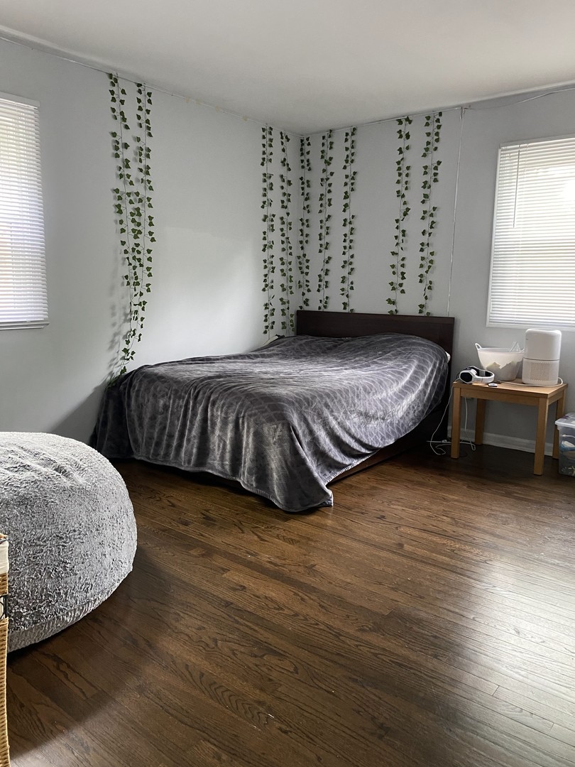 1408 Killdeer Drive Naperville, IL 60565 - Photo 31 of 43 a bedroom with a bed and wooden floor