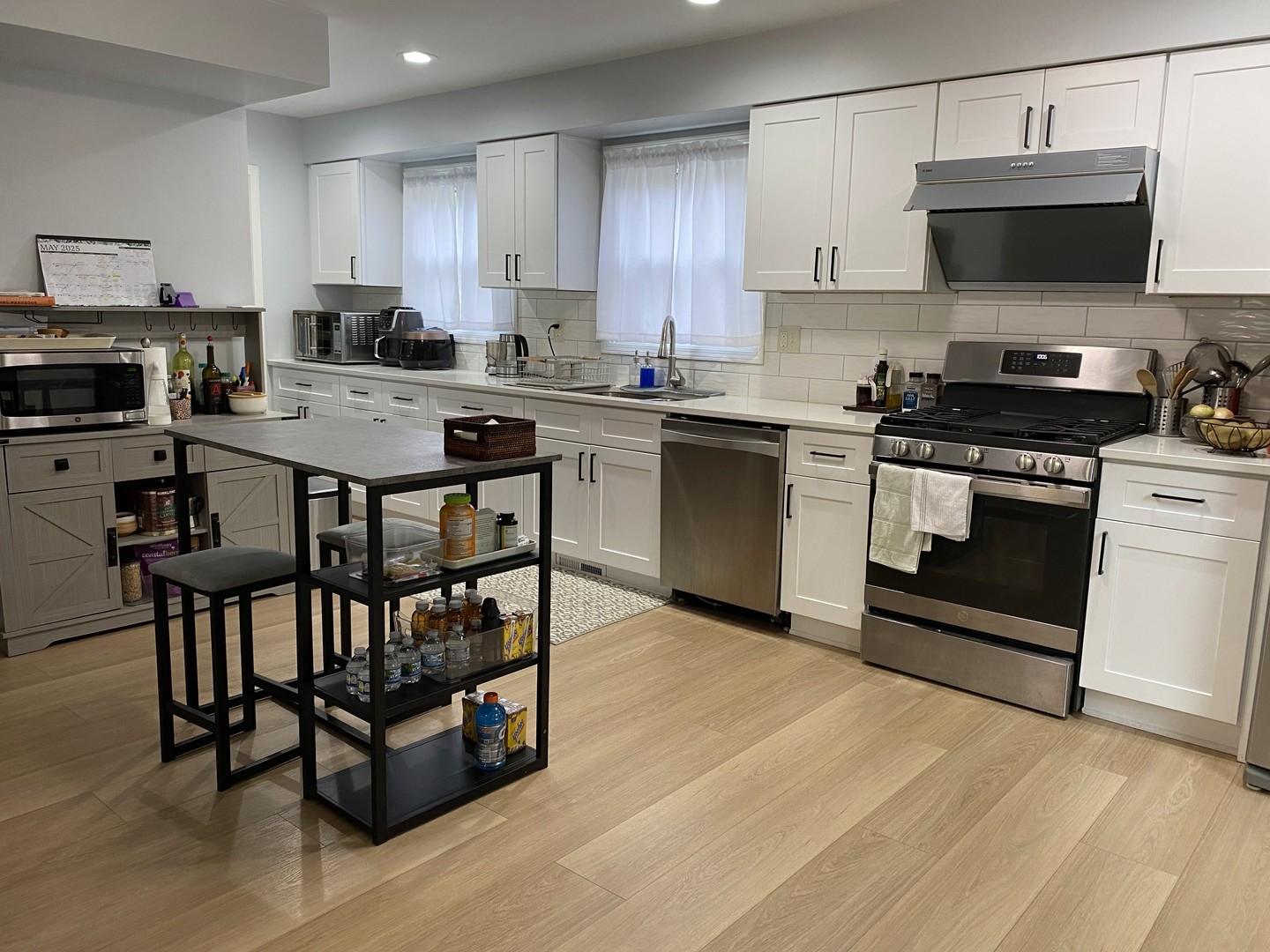 1408 Killdeer Drive Naperville, IL 60565 - Photo 7 of 43 a kitchen with stainless steel appliances a stove a sink a microwave a refrigerator and cabinets