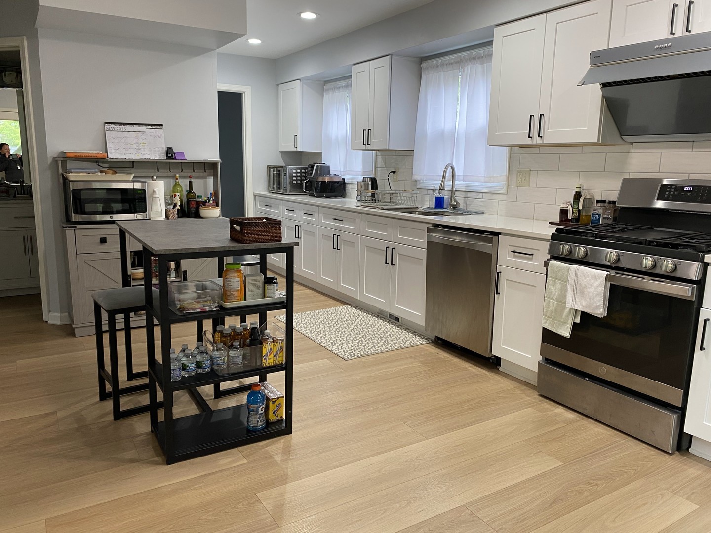 1408 Killdeer Drive Naperville, IL 60565 - Photo 9 of 43 a kitchen with stainless steel appliances a stove a sink dishwasher a microwave oven with cabinets and wooden floor