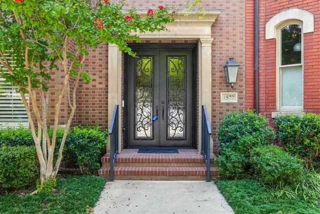 a front view of a house with a garden and plants