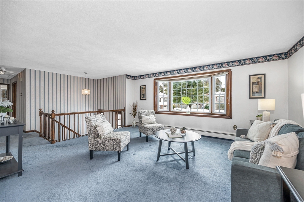 24 Benton Circle Reading, MA 01867 - Photo 11 of 41 a living room with furniture and a large window