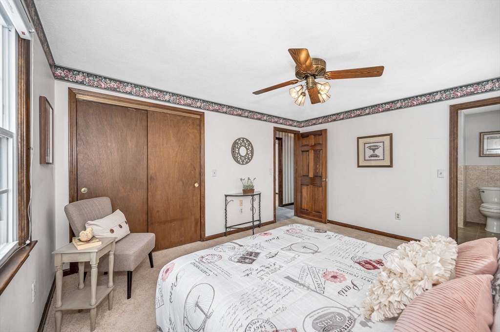 24 Benton Circle Reading, MA 01867 - Photo 18 of 41 a bedroom with a bed and wooden floor