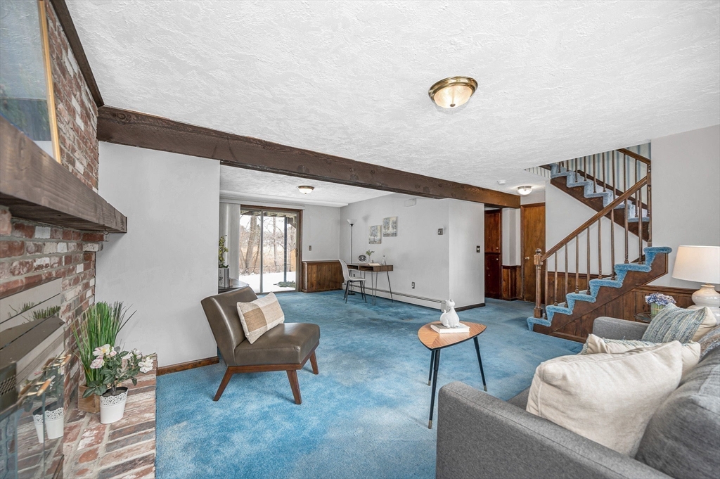 24 Benton Circle Reading, MA 01867 - Photo 29 of 41 a living room with furniture and a dining table