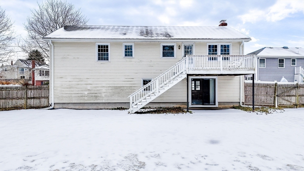 24 Benton Circle Reading, MA 01867 - Photo 40 of 41 a view of a house with a snow in the yard